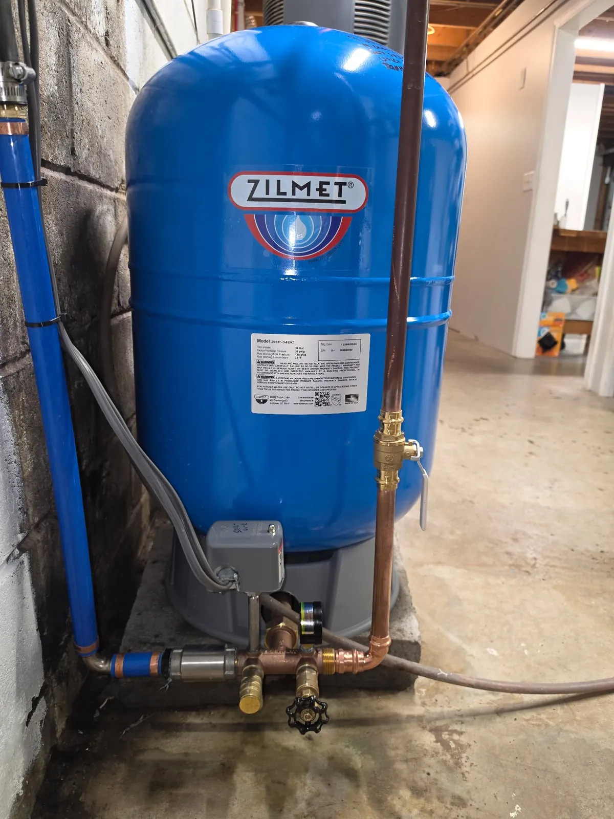New Zilmet well pressure tank with pressure switch, tank tee, gauge and copper press fittings installed in a Sherburne NY basement