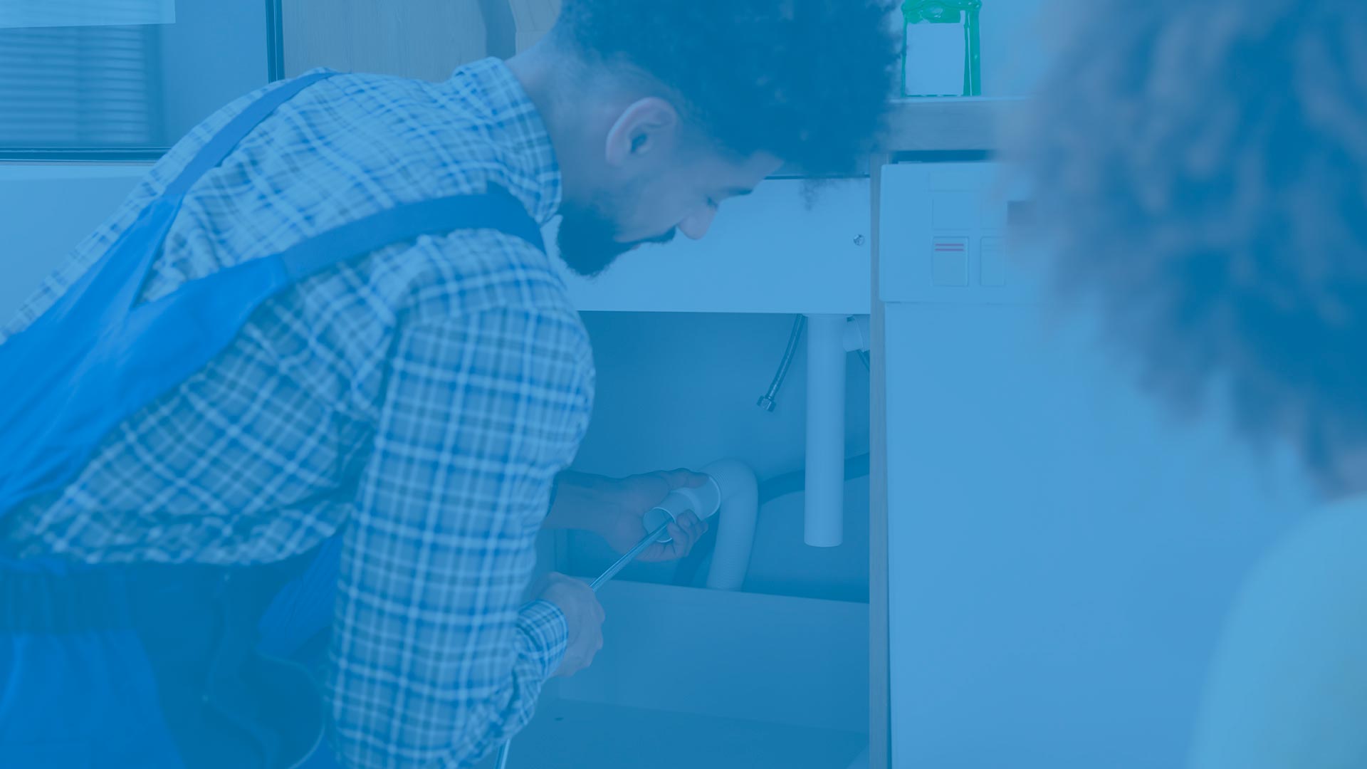 hero plumber cleaning drain under kitchen sink sherbune ny